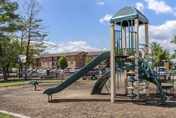 A playground with a green slide
